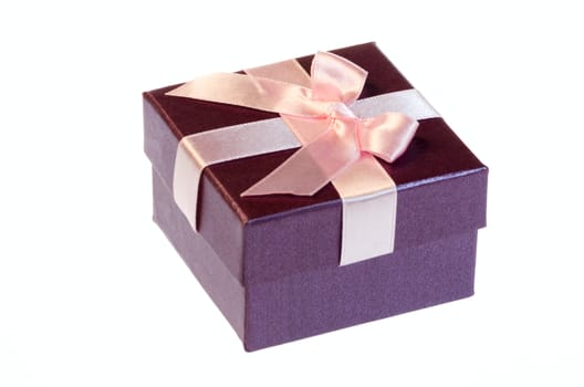 Gift box with a pink ribbon bow isolated on white background.