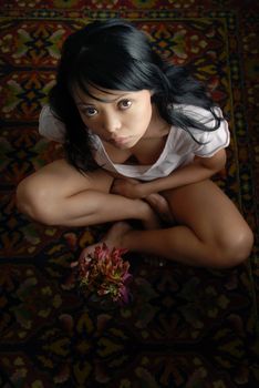 Sensual photo of the lady sitting on the carpet
