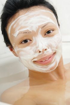 Closeup portrait of the woman in the bath with beauty mask