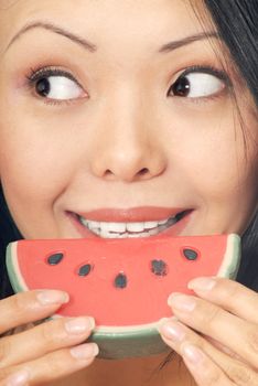 Smiling woman with melon looking to the sideward