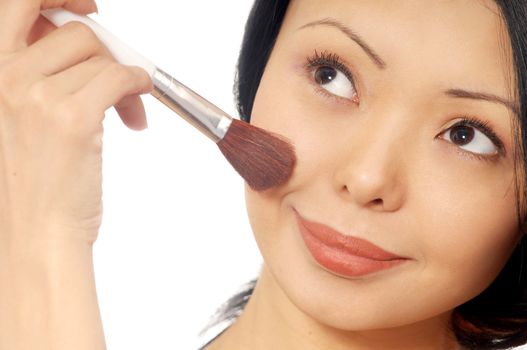 Photo of the smiling woman with face-powder brush