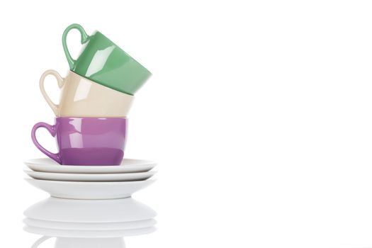 stapled purple, green and beige coffee cups on white background