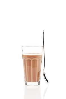 chocolate milk with a standing spoon on white background