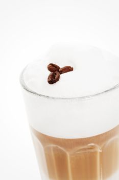 closeup of coffee beans on a latte macchiato foam