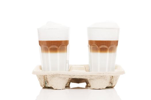 latte macchiato to go in cupholder on white background