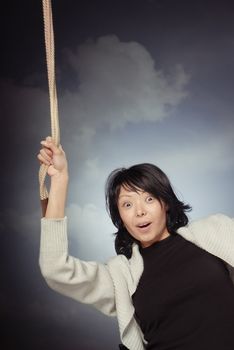 Funny lady falling and holding the rope on a sky background