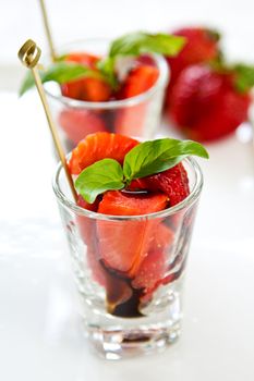 Strawberry with Balsamic sauce and basil in glass