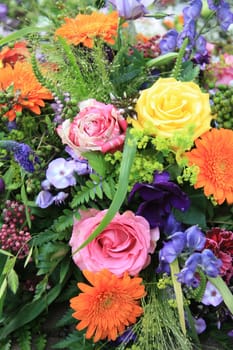 Multicolored floral arrangement with different sorts of flowers in bright colors