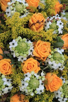 Yellow and white floral arrangement containing yellow roses and white lilies