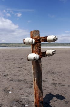 buried old wooden electricity pylons in the sand of Kuyal'nik Liman