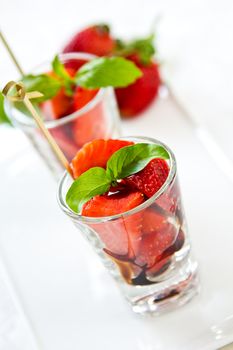 Strawberry with Balsamic sauce and basil in glass