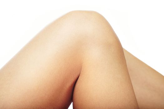 Close-up photo of the woman hips and knee on a white background