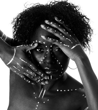 Beautiful cultural indigenous tribal African female face with arms and hands in front, white makeup cosmetics lines dots and curly hair, isolated.