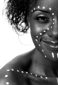 Half face of Happy smiling beautiful indigenous African tribal woman with white dots and lines makeup, isolated.