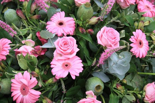 Flower arrangement with different pink flowers, like roses and gerberas