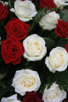big red and white roses in a flower arrangement
