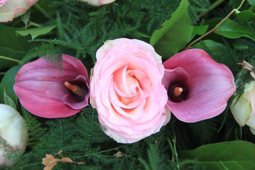 Floral arrangement with two pink arums and a pink rose
