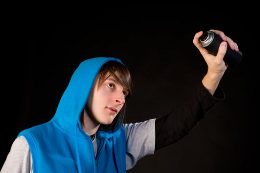 Teenager about to use a can of spray