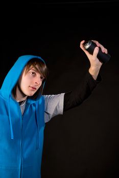 Teenager ready to start using a can of spray