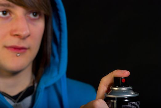 Teenager with his finger ready to start painting