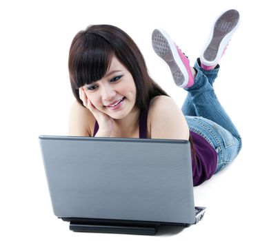 Portrait of a cute young Asian woman lying on floor with laptop over white background.