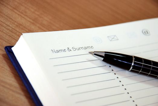 organizer with metallic black pen on desk