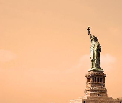 Statue of Liberty monument over orange background