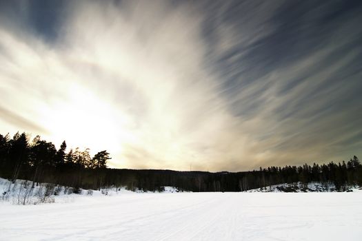 A dramatic landscape on a frozen lake.