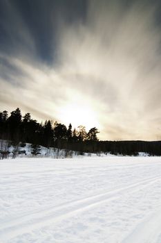 A dramatic landscape on a frozen lake.