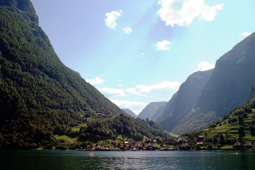 Fjord Scenic from the pass between Aurlandsfjord and naeroyfjord (n�r�yfjord), in Sognefjord, Norway.  Blue sky and sun with lens flare.