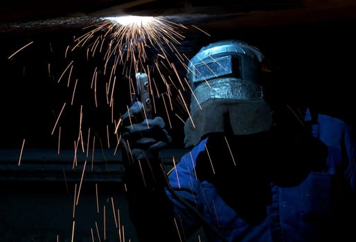 a welder working at shipyard at night