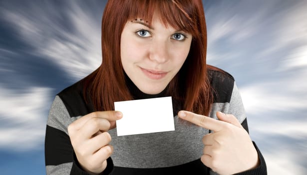 Girl pointing finger at a blank business card, smiling and cute.

Studio shot.