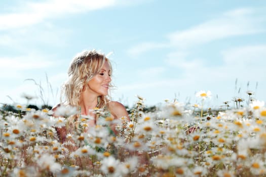 beautiful girl on the daisy flowers field 