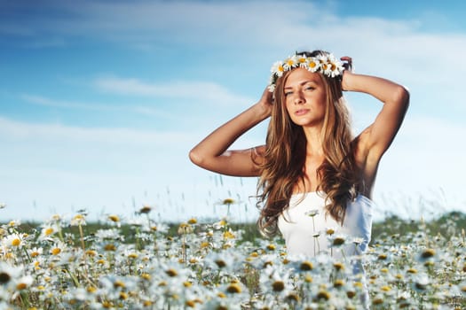 beautiful girl  in dress on the daisy flowers field 