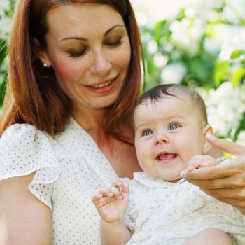 Mother and daughter close up portrait on flower background