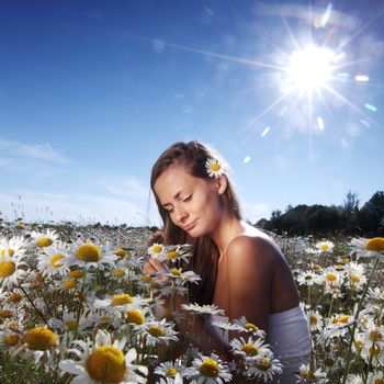  beautiful girl  in dress on the sunny daisy flowers field 