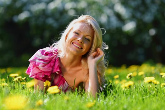  girl lying on the field of dandelions