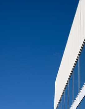 modern buildings windows with blue sky reflection