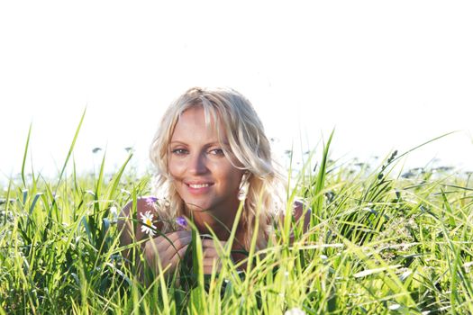 woman on green grass close up