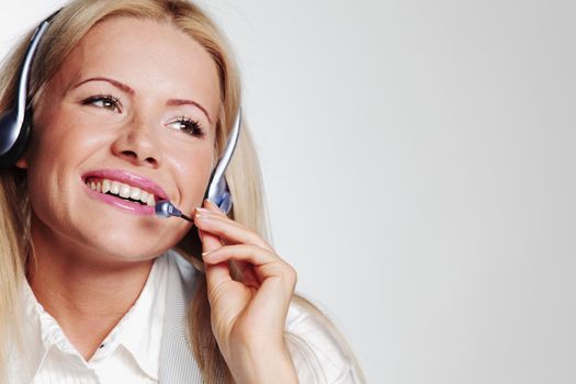 business woman in a headset on a gray background