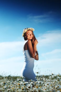 beautiful girl  in dress on the daisy flowers field 