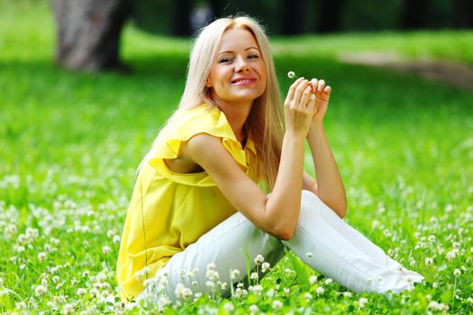 woman dachshund in her arms on grass