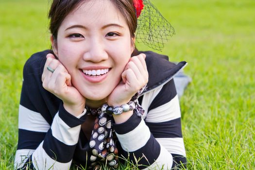 Asian woman relaxing on the grass