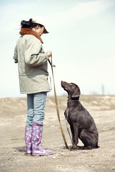 Woman and dog training outdoors
