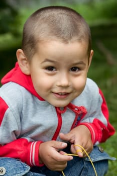 The smiling boy in a wood, a close up