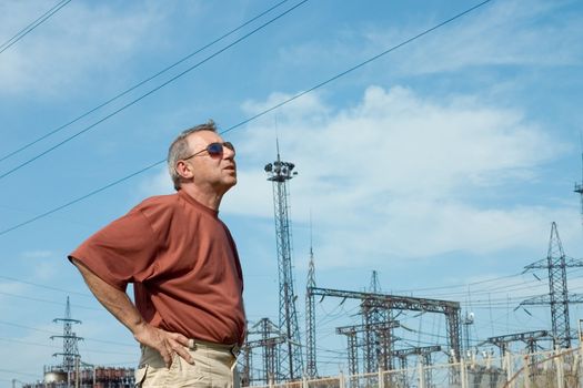 The man on a background of electric substation