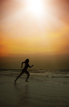 Active lady running at the beach during sunset. Special darkness and colors added