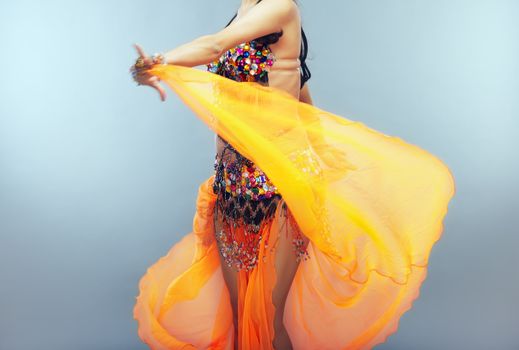 Dancing belly dancer moving her traditional dress