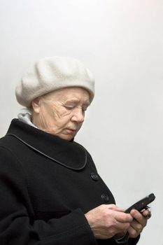 The elderly woman with mobile phone