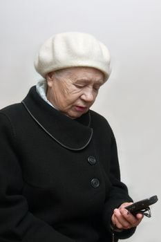 The elderly woman with mobile phone